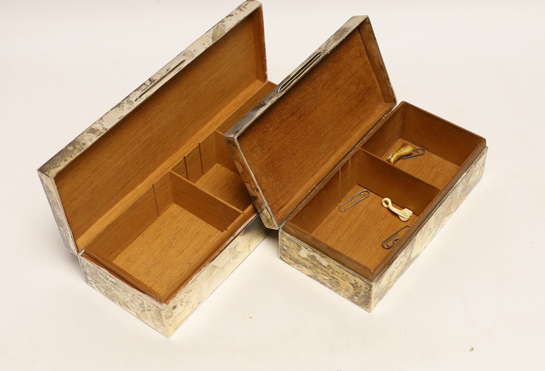 Two mid 20th century engine turned silver rectangular cigarette boxes, largest 24.2cm.